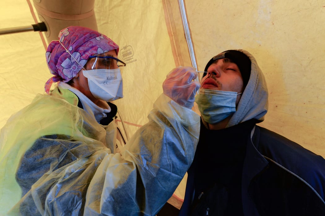 A man undergoes a rapid antigen test for Covid-19 after the evacuation of a giant illegal rave by French police.