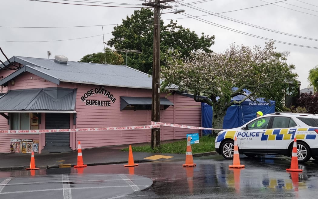 Police outside a dairy in the Auckland suburb of Sandringham where a man was fatally stabbed.