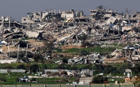 A picture taken from southern Israel shows destroyed buildings in the Gaza Strip on February 7, 2024, amid ongoing battles between Israel and the Palestinian militant group Hamas. (Photo by JACK GUEZ / AFP)