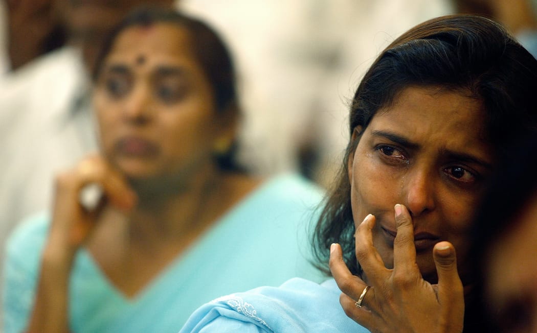 Vishakha Seksaria (right), who lost her brother Vrindesh in the 2006 blasts, weeps at a memorial function for the victims in Mumbai in 2007.