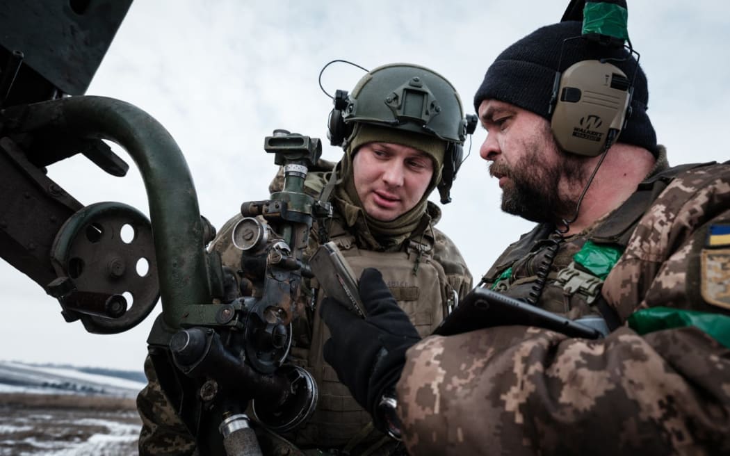 Ukrainian servicemen of the artillery unit of the 80th Air Assault Brigade talk near Bakhmut.