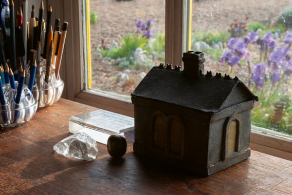 Jarman’s desk looks out across the shingle to the sea.