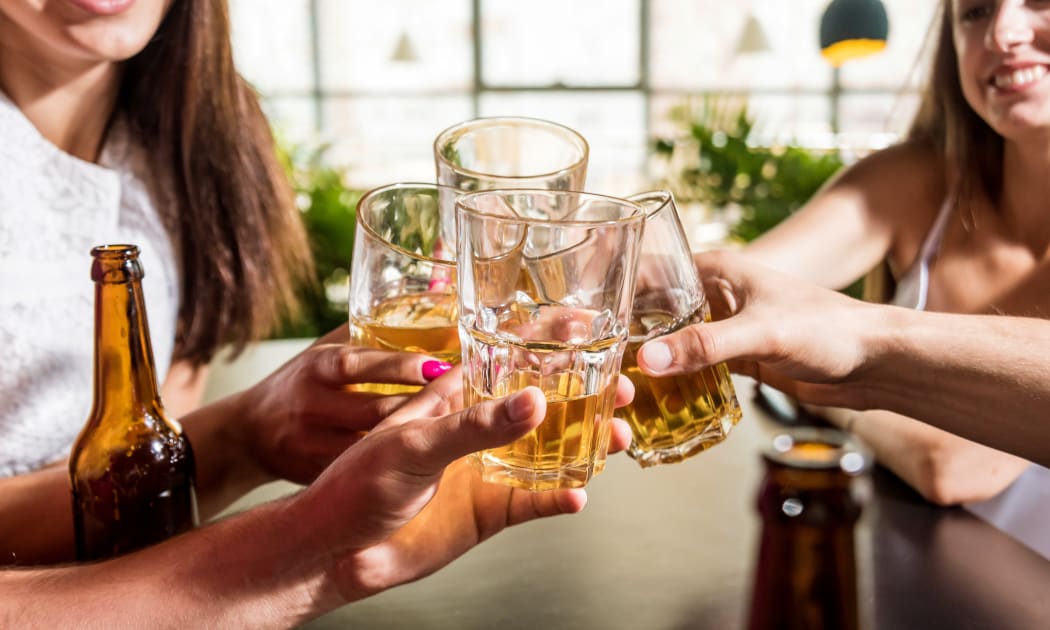 Cheerful friends in the pub. Drinking beer, talking, having fun. Meeting friends after work
