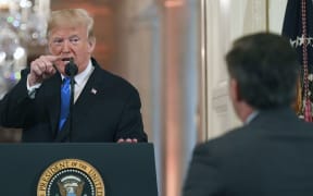 US President Donald Trump points to CNN journalist Jim Acosta during a post-election press conference in the White House.