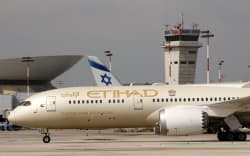 A closeup picture taken on February 20, 2022 shows an Etihad Airways Boeing 787 landing at Israel’s Ben Gurion International airport in Lod, on the outskirts of Tel Aviv. (Photo by JACK GUEZ / AFP)