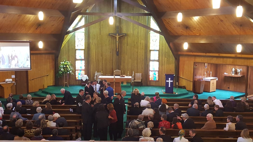 The requiem mass is being held at the Sacred Heart Catholic Church.