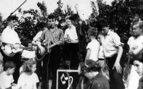 The Quarrymen, 1957. John Lennon with guitar in checked shirt