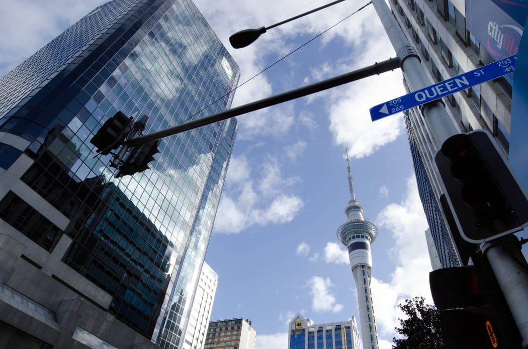 A clear day in Auckland, with the Sky Tower in the background and a Queen St sign in the foreground (file photo)