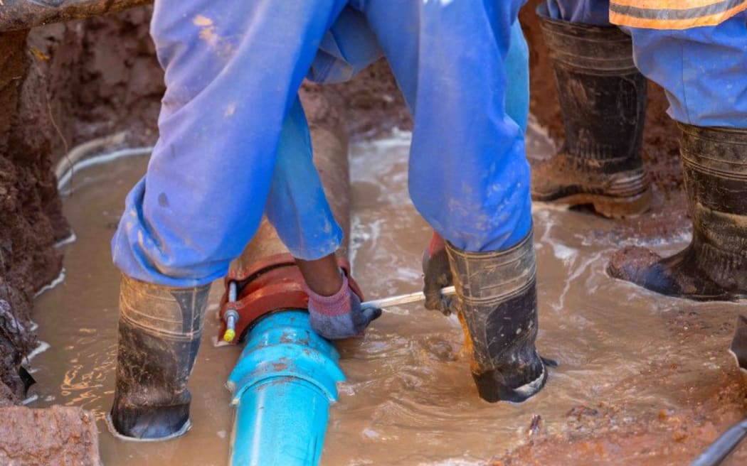 Contractors fixing a leak