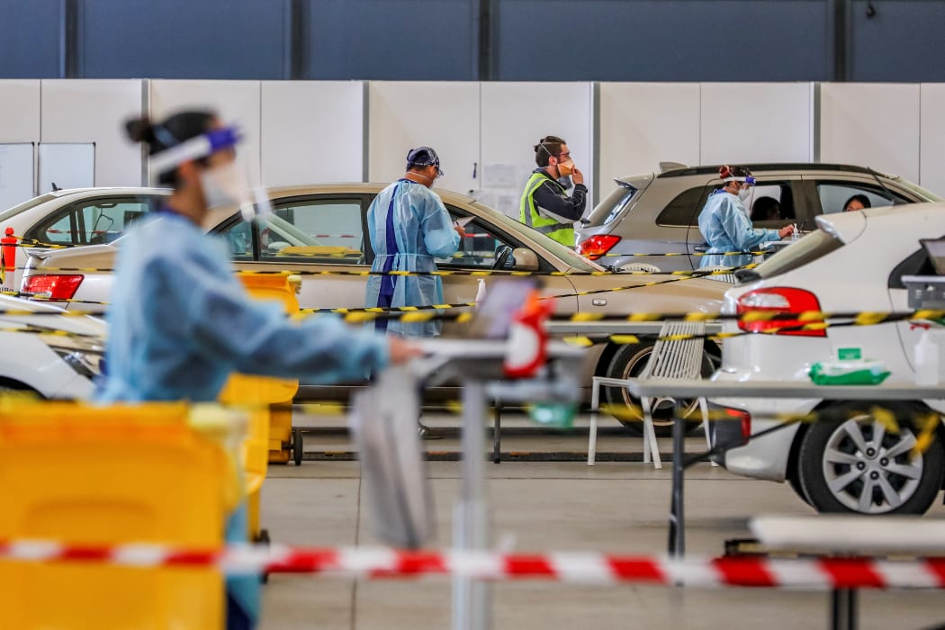 Residents in their cars queue at a drive-through Covid-19 testing facility at the Melbourne Showgrounds on 16 July, 2021.