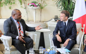 PNG Prime Minister James Marape, left, and French President Emmanuel Macron.
