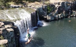 Tommy Lodge backflips from the top of the falls at Charlie’s Rock, on Kerikeri’s Waipapa River.