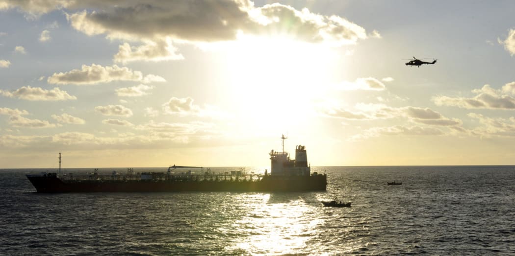 A South Korean navy's Lynx helicopter and a speedboat surround with South Korea UDT/SEAL members aboard approach the South Korean ship hijacked by Somali pirates in the Indian Ocean, rescuing all the crew and killing eight pirates on January 21, 2011.