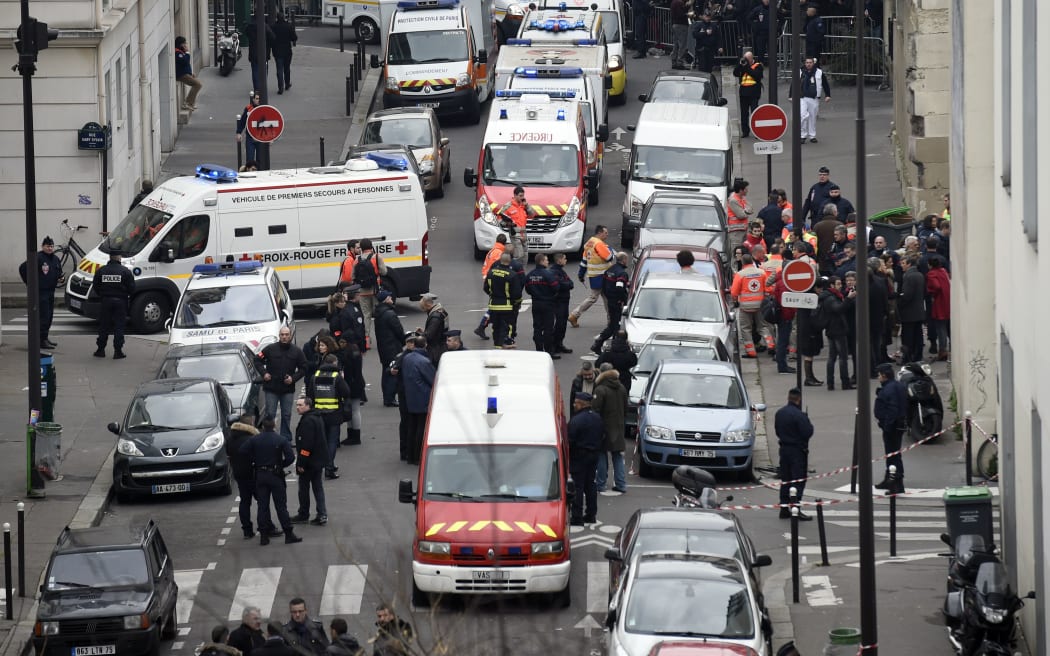 Firefighters, police officers and forensics gathered in front of the offices of the French satirical newspaper Charlie Hebdo.