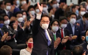 Japan's new Prime Minister Fumio Kishida celebrates after winning  Liberal Democratic Party (LDP) vote.