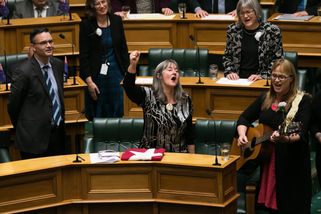 Departing Green MP Catherine Delahunty sings with her colleagues in the House after her valedictory speech.