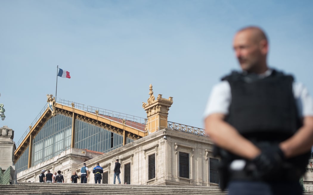 A French police officer stands outside Saint-Charles train station in Marseille on October 1, 2017, after a man armed with a knife killed two people before being shot by soldiers patrolling the area.