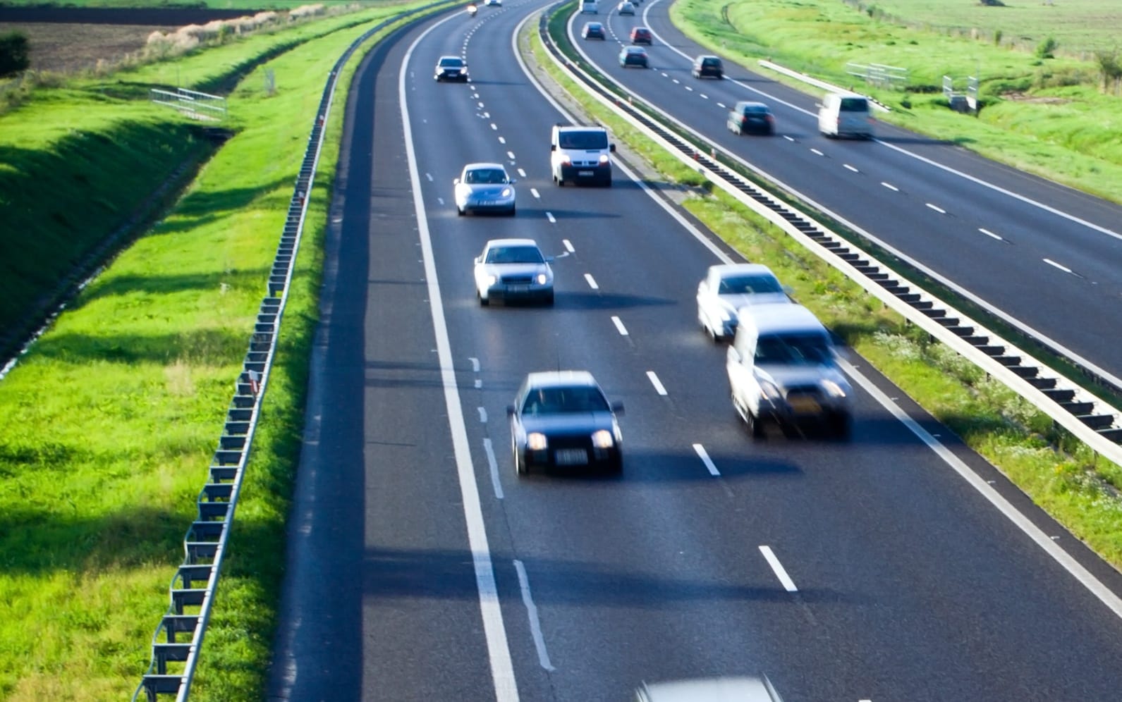A file photo shows blurred cars on a four-lane highway.