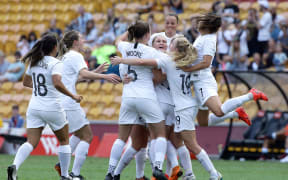 New Zealand's CJ Bott, center, celebrates with the team after scoring a goal.