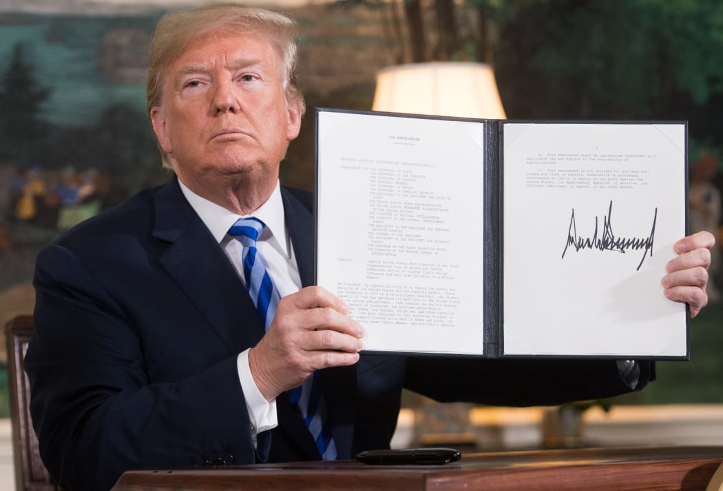 US President Donald Trump signs a document reinstating sanctions against Iran after announcing the US withdrawal from the Iran Nuclear deal.