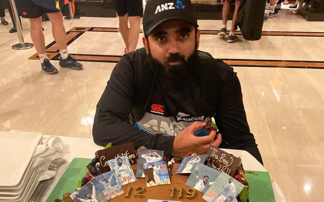 Ajaz Patel enjoys the cake hotel staff made for him to celerbrate his ten wicket achievement in Mumbai.