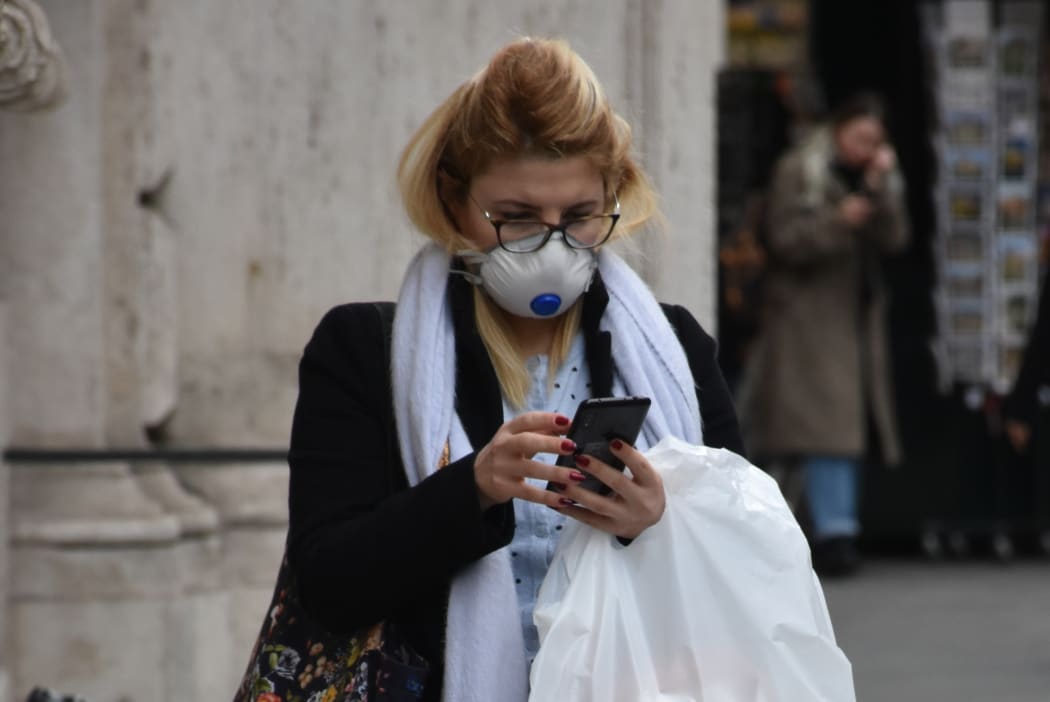 A woman wearing a face masks in Rome.