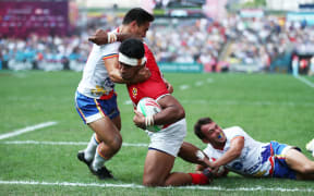 Tonga's Josh Moala-Liava'a charges through the Philippines defence during the World Series Qualifier in Hong Kong.