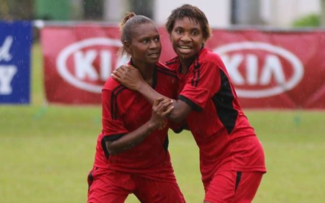Papua New Guinea defender Belinda Giada [R] celebrates one of her two goals against Cook Islands.