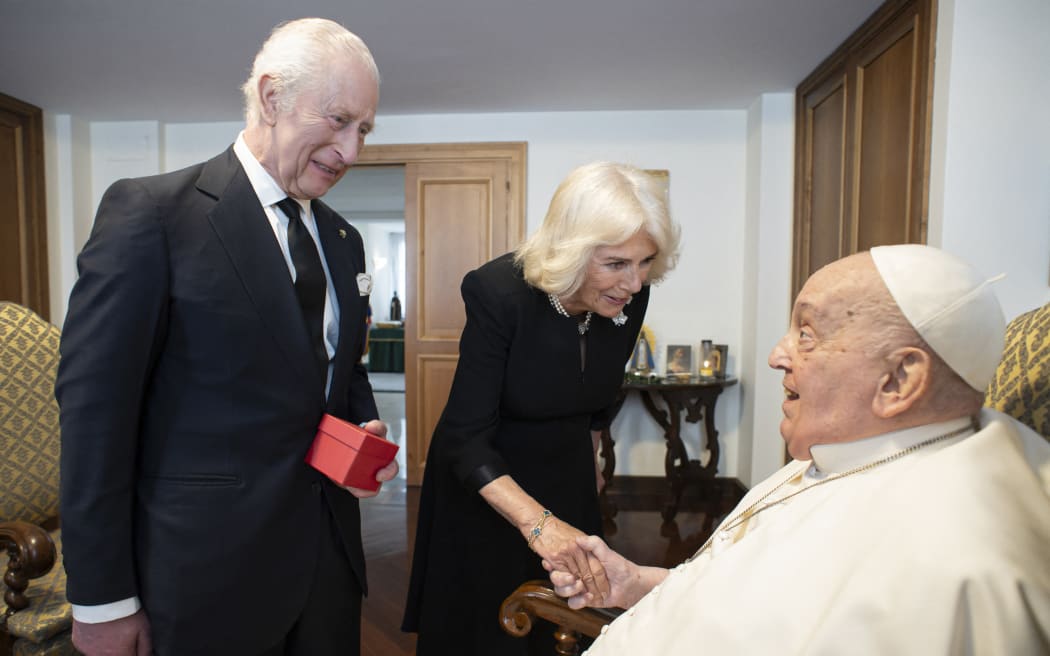 This photo taken on April 9, 2025 and handout on April 10, 2025 by The Vatican Media shows Pope Francis during a private meeting with Britain's King Charles III and Queen Camilla in The Vatican.