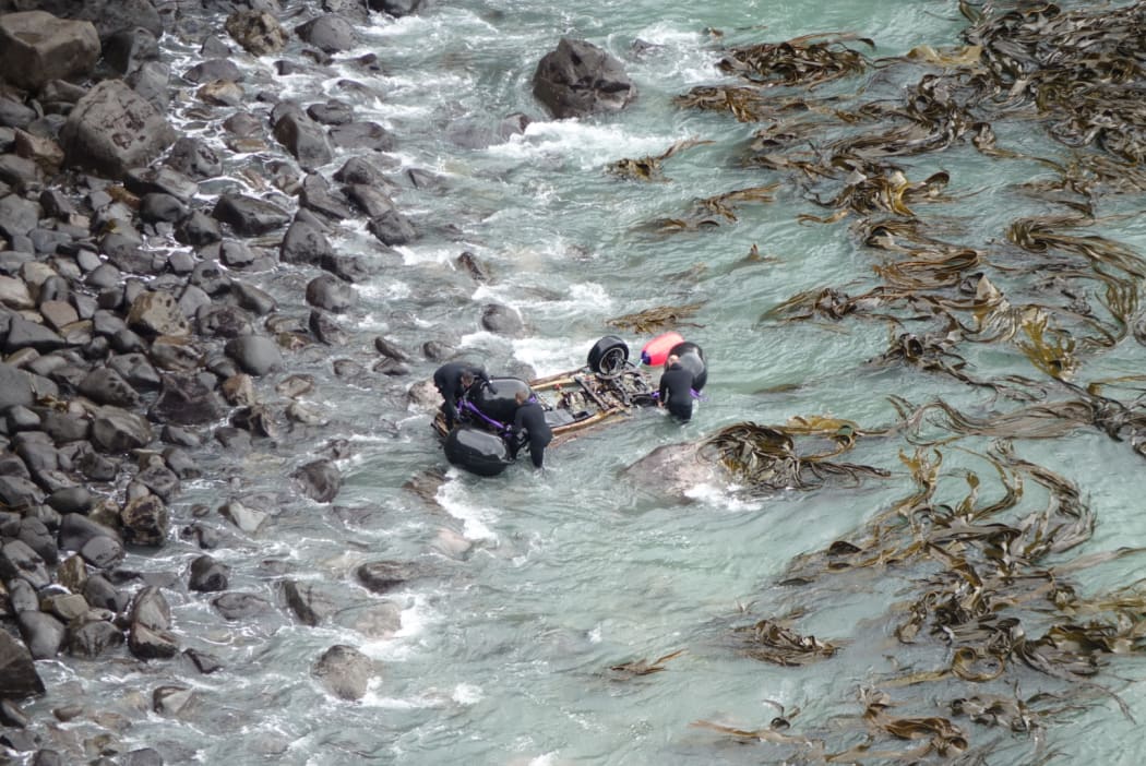 A helicopter lifted the wreck before dropping it closer to the cove's rocky shore.