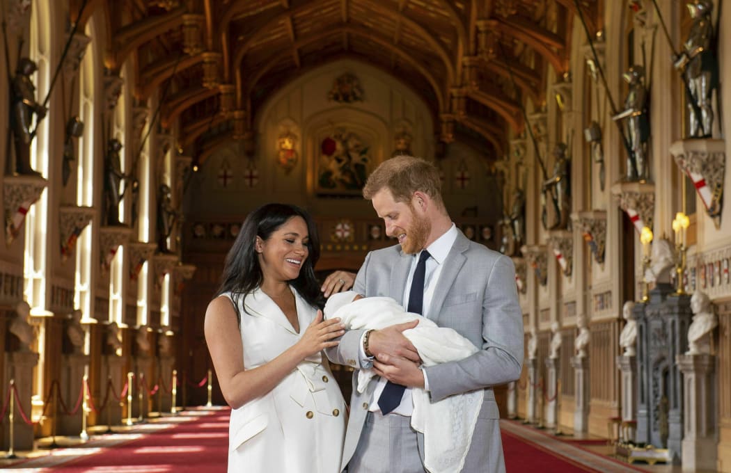 Britain's Prince Harry and Meghan, Duchess of Sussex, during a photocall with their newborn son, in St George's Hall at Windsor Castle, Windsor, south England, Wednesday May 8, 2019.
