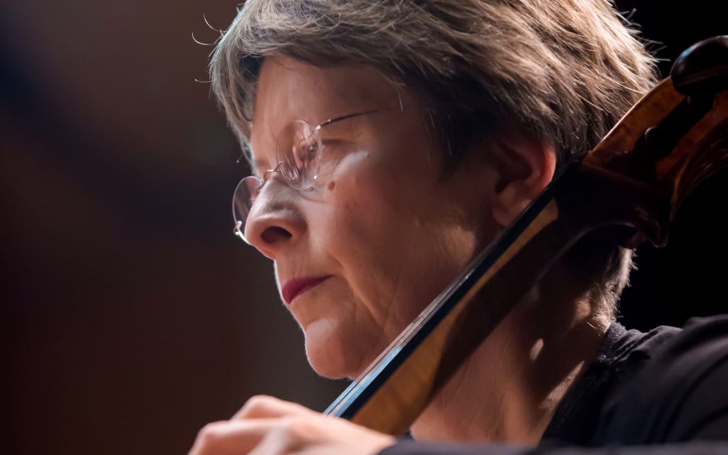 Close up of NZSO cellist Brigid O'Meeghan playing her instrument.