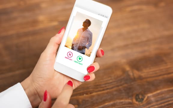 woman looks at online dating profile