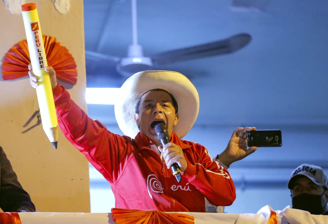 Peruvian leftist presidential candidate for Peru Libre party Pedro Castillo delivers a speech to supporters from a balcony at his campaign headquarters during his closing rally in Lima.