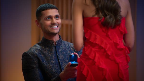 A still from Love Is Blind UK season 2, showing participant Kal Pasha proposing to a potential fiancee.