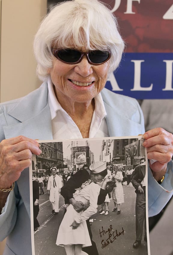 Ninety one-year-old Edith Shain poses with a photo of her famous kiss with a sailor on V-J Day at the end of World War II April 20, 2010 in San Francisco, California. Shain, who claims to be the nurse in the famous kiss picture that was photographed by Alfred Eisenstaedt was meeting with veterans at the VA Hospital as part of her 