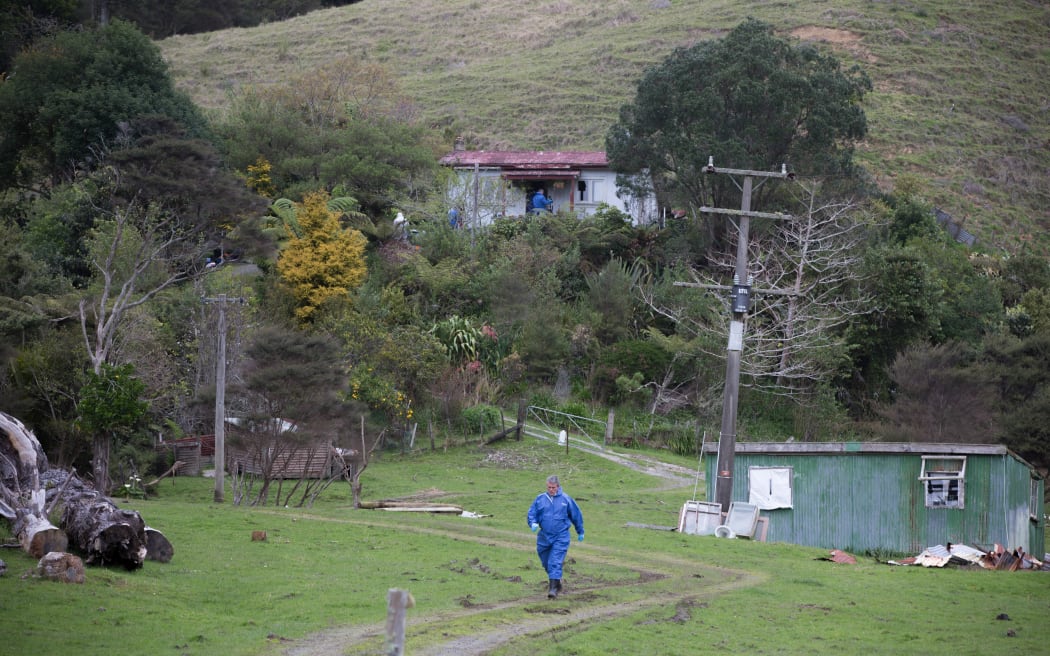 A crime scene investigator leaves the Taharoa property where 3 bodies were found yesterday. 8 October 2016.
