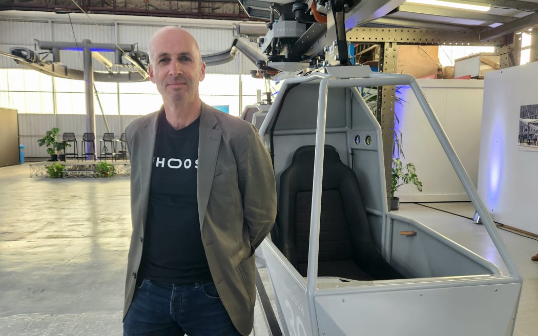 Whoosh head Dr Chris Allington beside a prototype Whoosh vehicle in Christchurch