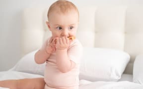 Baby with teething toy