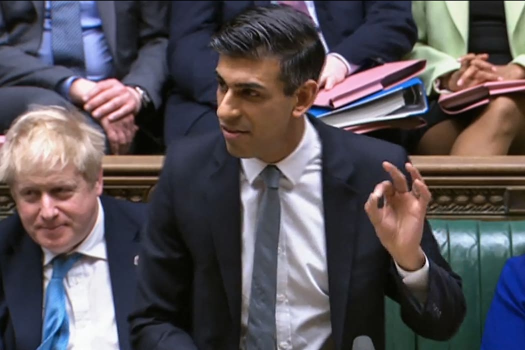 A video grab from footage broadcast by the UK Parliament's Parliamentary Recording Unit (PRU) shows Britain's Chancellor of the Exchequer Rishi Sunak gesturing as he presents the Spring budget statement to MPs.