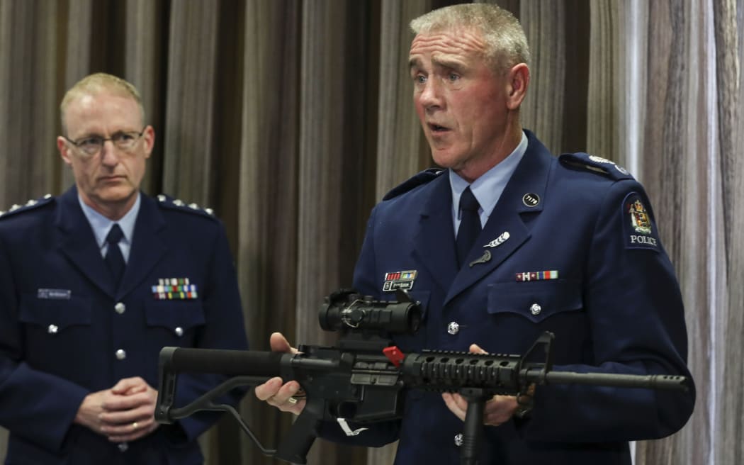 Senior Sergeant Paddy Hannon shows media a Norinco-5-point-56, a mock of the M16 rifle, which is now illegal.