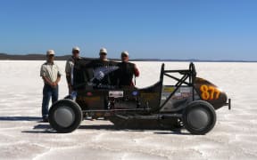 Description of Dave Alexander and team in front of vehicle