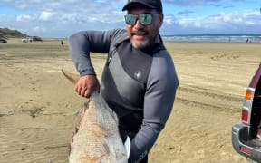 Kaitāia man Harley Ra with the snapper than earned him more than $30,000.