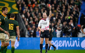 Referee Wayne Barnes shows a red card to New Zealand captain Sam Cane during the Rugby World Cup final between the All Blacks and South Africa at Stade de France.