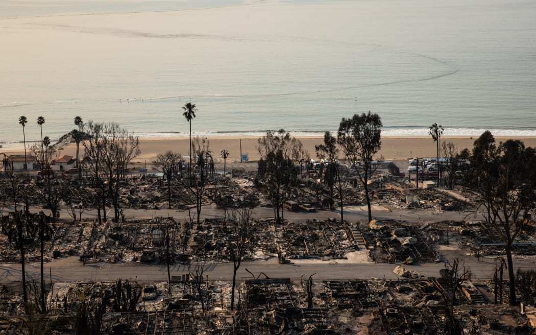 The Tahitian Terrace mobile home park on Pacific Coast Highway, destroyed in the Palisades Fire, is seen in the Pacific Palisades neighborhood of Los Angeles, California, on January 10, 2025. Massive wildfires that engulfed whole neighborhoods and displaced thousands in Los Angeles have killed at least 10 people, authorities said, as California's National Guard soldiers readied to hit the streets to help quell disorder.
News of the growing toll, announced late Thursday January 9 by the Los Angeles County Medical Examiner, came as swaths of the United States' second-largest city lay in ruins. (Photo by Zoë Meyers / AFP)