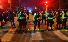 State troopers form a line in the street in Minneapolis, Minnesota, on January 14, 2026, after protesters clashed with federal law enforcement following the shooting of a Venezuelan man by a Immigration and Customs Enforcement (ICE) agent. A federal immigration agent shot a man January 14 in Minneapolis, city officials said, urging the public to "remain calm" a week after agents shot and killed an American woman in the same city.
Minneapolis Police Chief Brian O'Hara said the shooting resulted from a struggle in front of a residence between a man and an Immigration and Customs Enforcement (ICE) agent on the north side of the city. (Photo by Octavio JONES / AFP)