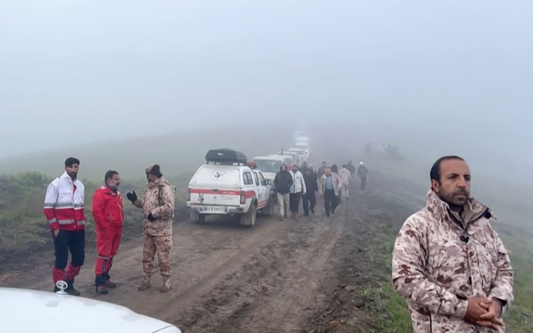 This frame grab from video released by the Iranian Red Crescent on May 20, 2024 shows members of a search and rescue team in Iran's East Azerbaijan province where Iran's President Ebrahim Raisi's helicopter was involved in "an accident". Rescue teams in northwest Iran early May 20 located the missing helicopter carrying President Ebrahim Raisi but no signs of life had been detected so far, state TV reported. (Photo by Handout / Iranian Red Crescent / AFP)