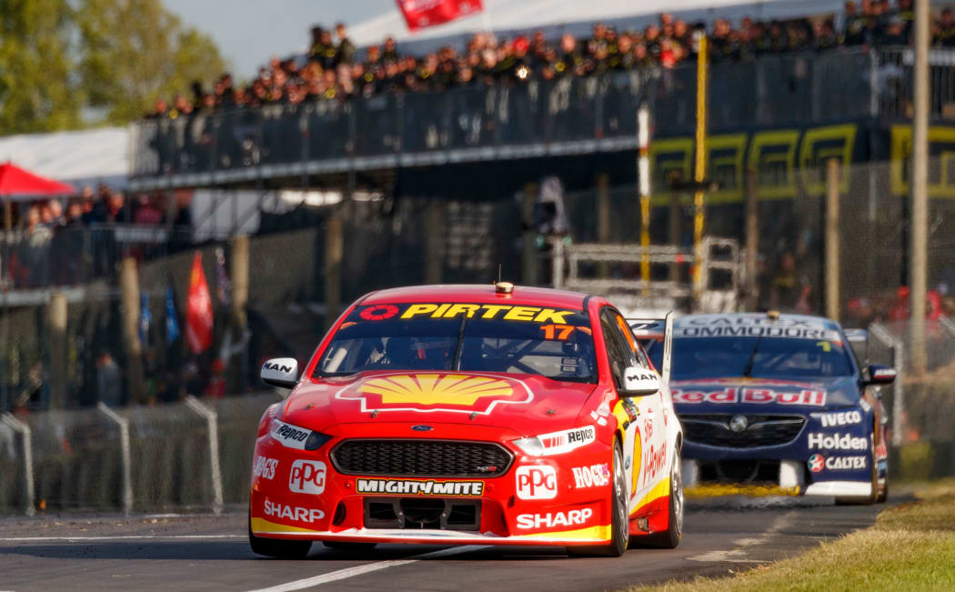 Scott McLaughlin crosses the finish line to win race two of the 2018 Supercars event at Pukekohe ahead of fellow Kiwi driver Shane van Gisbergen.
