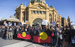 Protestors hold banners and chant slogans during a Black Lives matter rally in Melbourne, Australia.