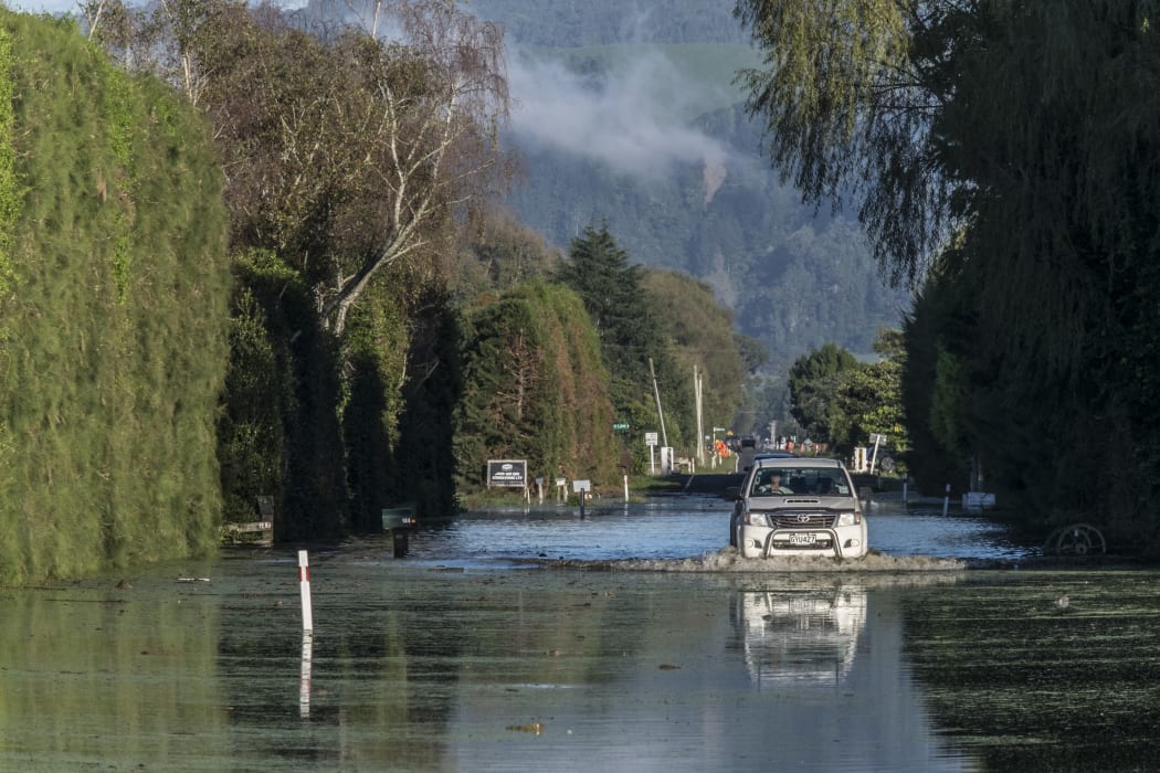 A farmer drives through flood waters on Otaiki Road the morning after the town of Edgecumbe was flooded by a burst stopbank.  Friday 7 April 2017